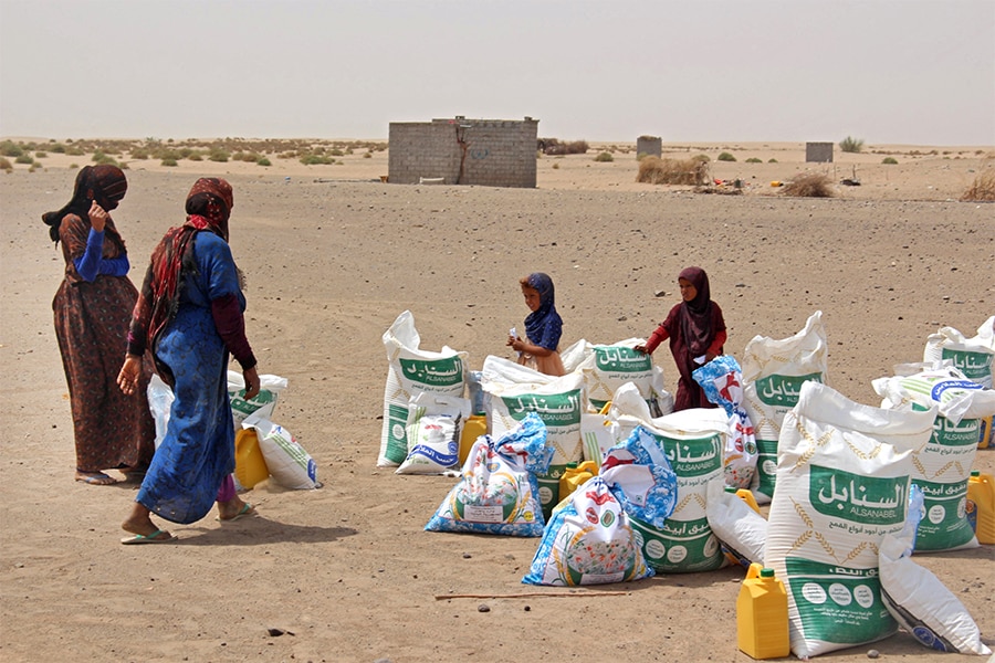 Yemeni families receive flour rations and other basic food supplies from charitiesin the province of Lahj, in southern Yemen, as food prices have doubled since last year and the fact that Ukraine supplies nearly a third of Yemen's wheat imports has heightened fears of a deepening famine. The disruption in export flows resulting from Russia's invasion and international sanctions has spurred fears of a global hunger crisis. (Credit: Saleh Al-OBEIDI / AFP)