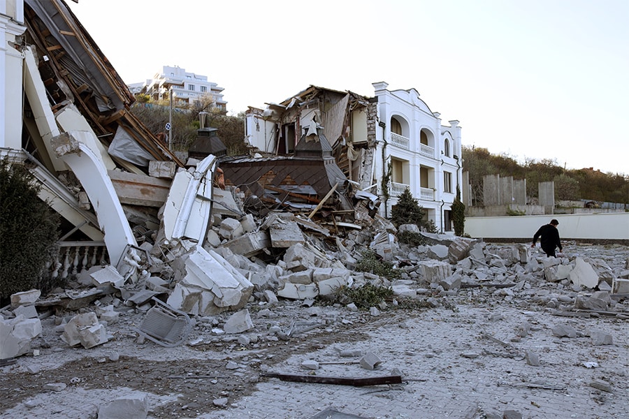 A man walks past beach hotel destroyed in Ukrainian city of Odessa on May 8, 2022, amid the Russian invasion of Ukraine.​​ (Credits: OLEKSANDR GIMANOV / AFP)