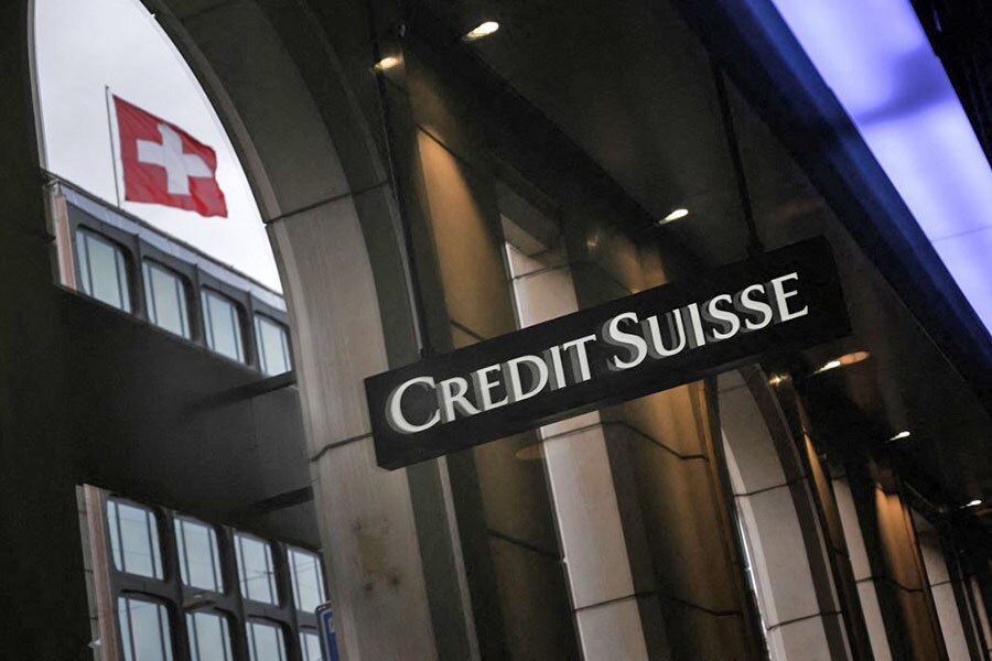 This photograph shows a sign of Switzerland's second largest bank Credit Suisse on a branch's building next to a Swiss flag in downtown Geneva. Image: Fabrice COFFRINI / AFP

