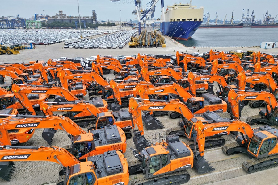 This aerial photo shows newly-produced excavators to be exported at a port in Yantai in China's eastern Shandong province, August 7, 2022. Image: STR / AFP

