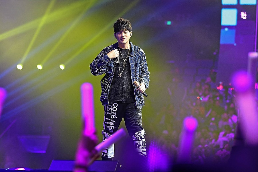  The most beloved Chinese pop star of the last decade, Jay Chou, a singer-songwriter in the alt-rock style,  performs at a shopping festival gala in Shanghai. <br>Image: STR / AFP 