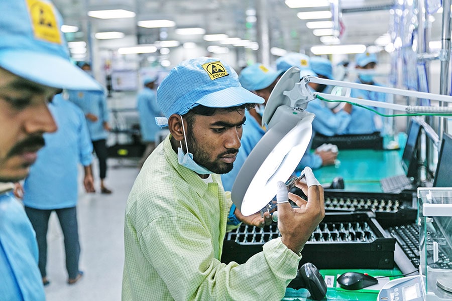 Technicians working in electronics manufacturing company, Dixon Technologies based in Noida. It is a contract manufacturer of televisions, washing machines, smartphones, LED bulbs, battens, downlighters and CCTV security systems for companies such as Samsung, Xiaomi, Panasonic and Philips.  Image credit: Madhu Kapparath 