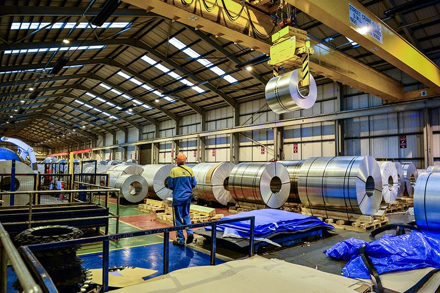 Steel worker uses a crane to handle rolls of steel at Tata Steel's Wednesbury site in Willenhall, Wolverhampton. 
Image: Ben Birchall/PA Images via Getty Images 