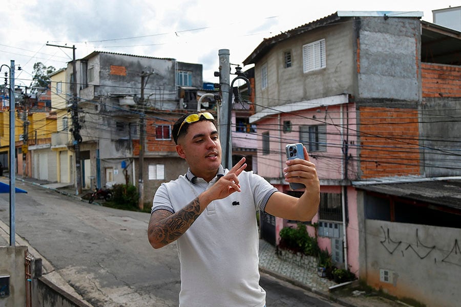 
Influencer Murilo Duarte streams a live video at the Jardim João XXIII slum in Sao Paulo, Brazil, on April 19, 2023.
Image: Miguel Schincariol / AFP©