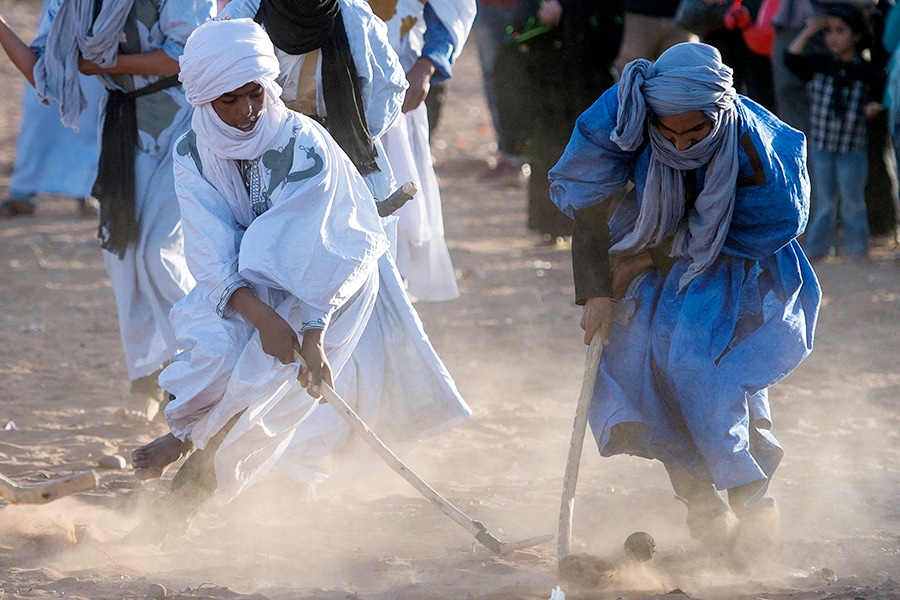 Locals play hockey during the 15th International Nomad Festival in Mhamid el-Ghizlane in Morocco's southern Sahara desert Photography Fadel Senna / AFP 