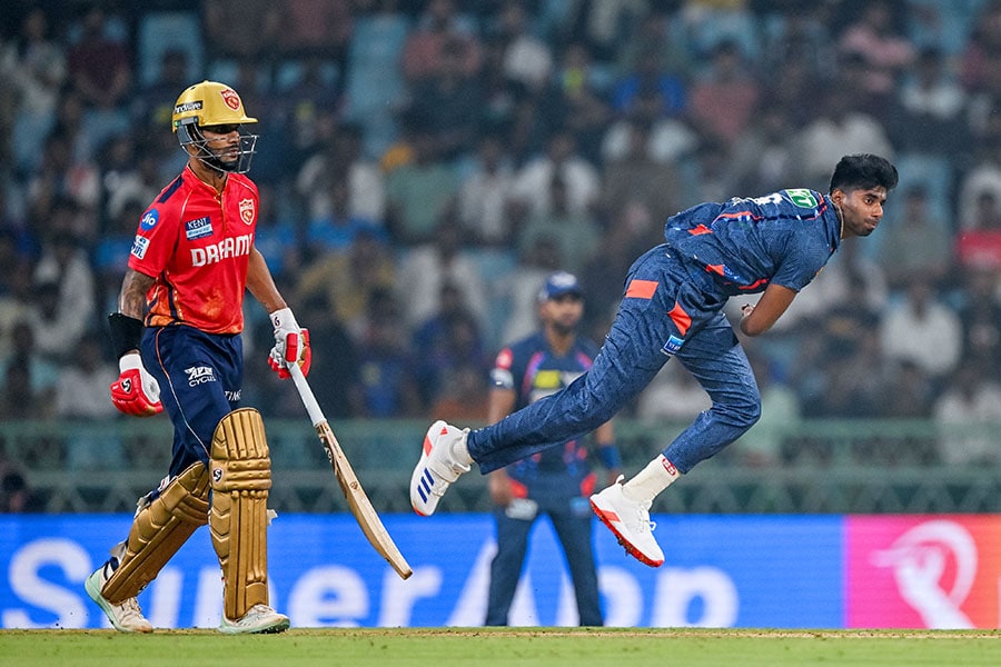 Lucknow Super Giants' Mayank Yadav bowls as Punjab Kings' captain Shikhar Dhawan (L) watches during the Indian Premier League (IPL) Twenty20 cricket match between Lucknow Super Giants and Punjab Kings at the Ekana Cricket Stadium in Lucknow on March 30, 2024.
Image: Arun Sankar / AFP