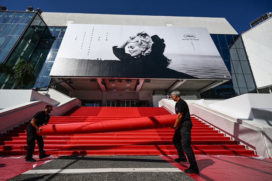 Workers prepare the red carpet ahead of the opening of the 76th Cannes Film Festival in Cannes, southeastern France, on May 16, 2023. Image: CHRISTOPHE SIMON / AFP