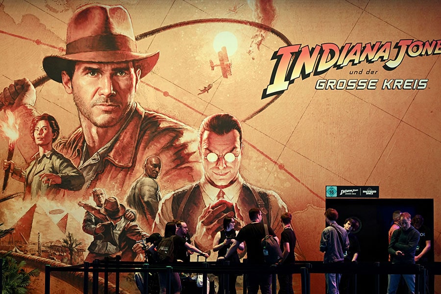 Visitors stand at the booth of the video game 'Indiana Jones and the Great Circle' during the media day at the Gamescom video games trade fair in Cologne.
Image: Ina Fassbender / AFP©