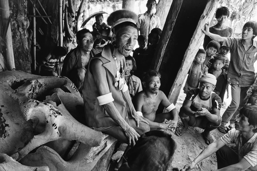 Wangkau, the Great Ang (chief) of Chui, holds the court seated on an elephant-skull throne. The Ang is the temporal and spiritual head of the Konyak. When he leaves the village for an extended period, a small wooden figure, monglei, is placed on the throne. Image: © Aditya Arya