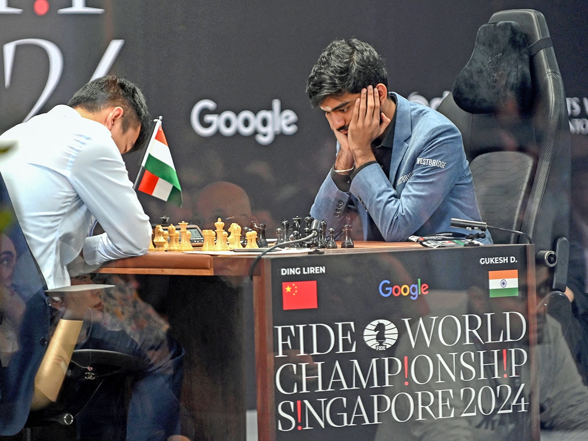  China's chess grandmaster Ding Liren (L) and India's grandmaster Gukesh Dommaraju (R) compete in game 14 of the 2024 FIDE World Championship in Singapore on December 12, 2024. - World chess champion Ding Liren, 32, from China, was defending his crown against 18-year-old Indian prodigy Gukesh Dommaraju.
Image: Simon Lim / AFP