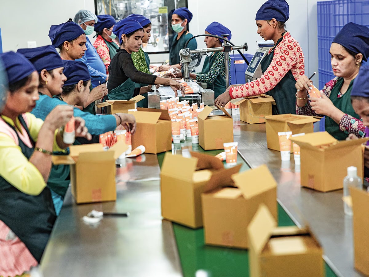 Workers assemble cosmetics tubes at the Indo Herbal manufacturing unit in Haridwar. Image: Madhu Kapparath