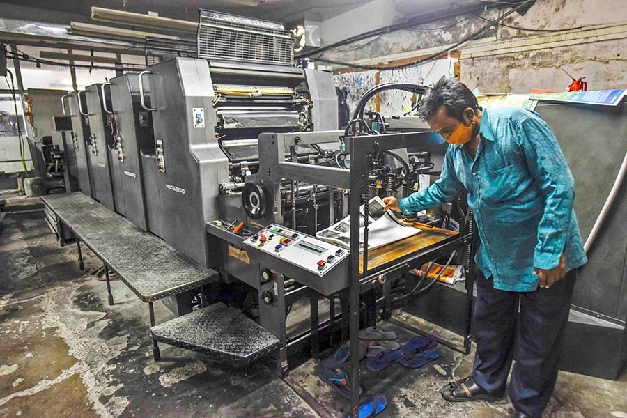 A man working on an offset printer at a printing unit at Okhla industrial area in New Delhi, India. Image: Biplov Bhuyan/Hindustan Times via Getty Images