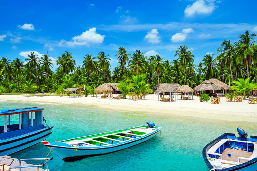 Tropical aerial seascape with jetty, water bungalows villas at sea lagoon beach in Maldives paradise island. Image: Shutterstock