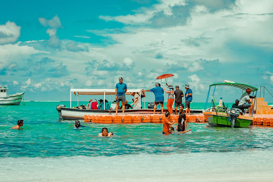 Tourists at Kavaratti Island, Lakshadweep enjoying their time at the coral paradise of India. Image: Shutterstock