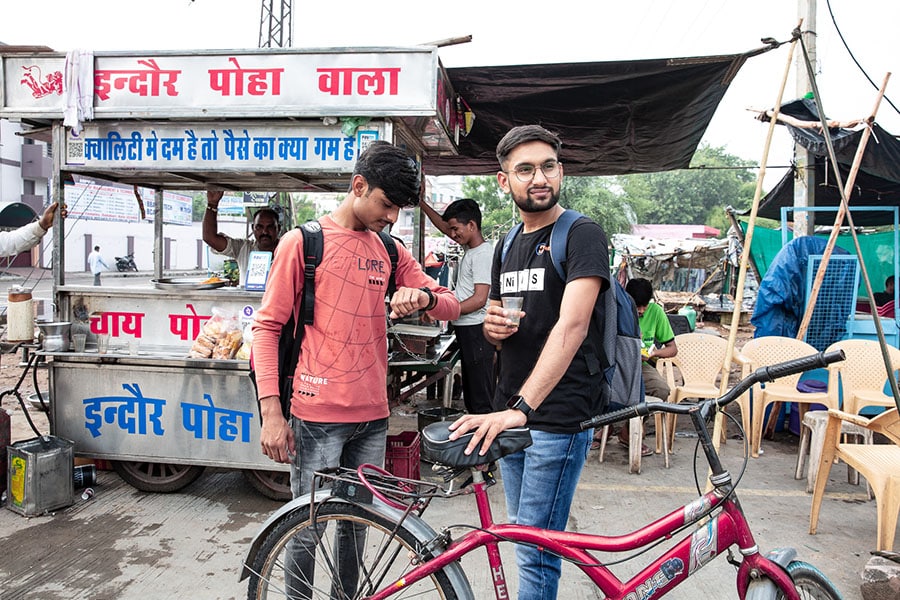 Vikas Patidar came to Kota from Indore to become a doctor. The journey in the city, he says, is not easy. It's a mental, physical, emotional and financial investment. He cycles his way to a coaching centre, stopping on the way for some breakfast as the only form of recreation and exercise on most days. Image: Madhu Kapparath 