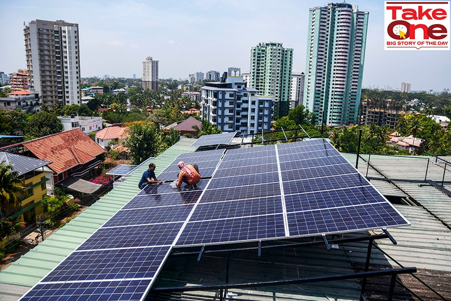 Workers install solar panels on the roof of a residential apartment in Kochi, southern Kerala state, India.
Image: AP Photo/R S Iyer