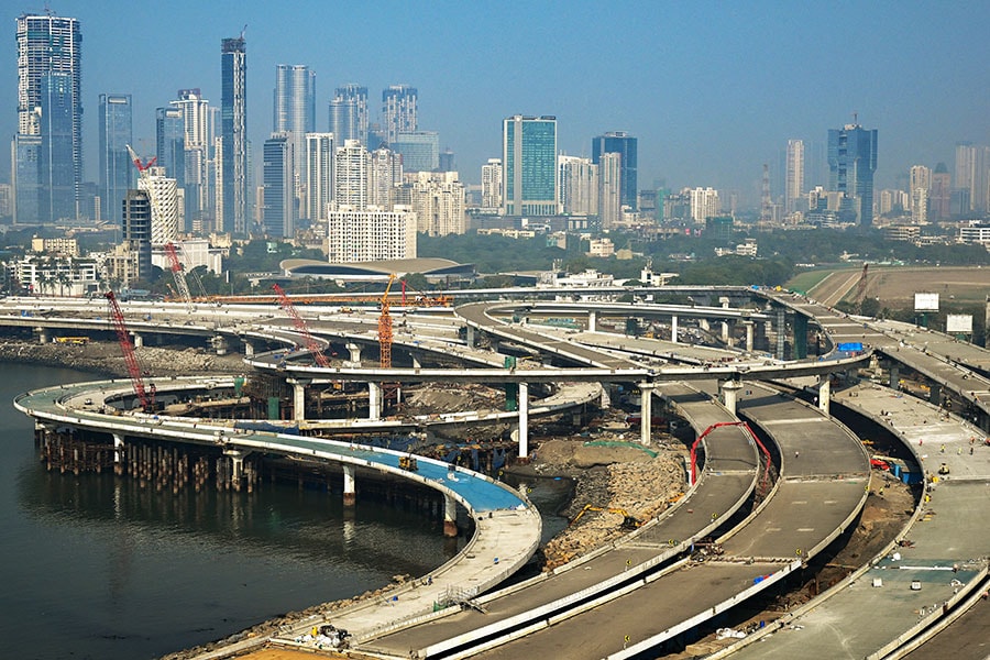 Labourers work on an under construction portion of the Coastal Road expressway along the Arabian Sea coastline of Mumbai. 
Image: Indranil Mukherjee / AFP 