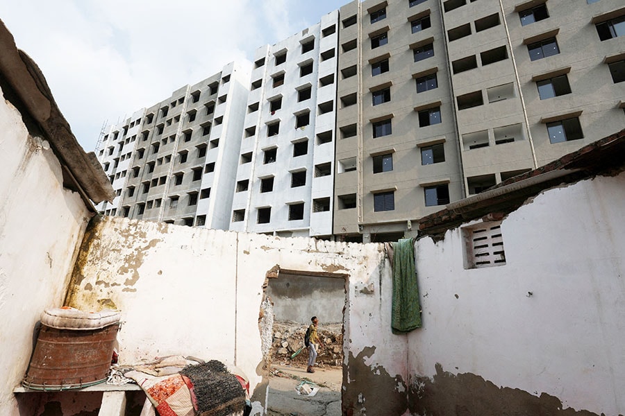 A man walks past an under construction residential building of Pradhan Mantri Awas Yojana in Ahmedabad, India on July 18 , 2024.
Image: Amit Dave / Reuters