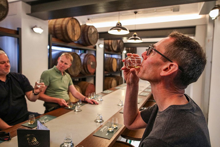 Visitors taste whisky on May 17, 2024 at the former Crumlin road jail, in central Belfast, which imprisoned IRA and Loyalist prisoners. Image: Photography Paul Faith / AFP