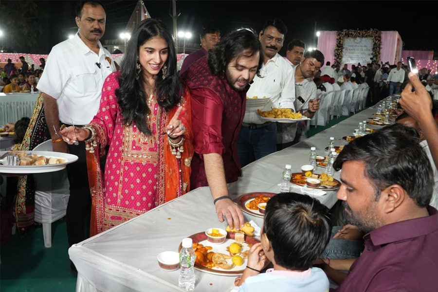 Bride-to-be Radhika Merchant and groom-to-be Anant Ambani serve food during Anna Seva on Wednesday, February 28, 2024 at Jogwad, Jamnagar, Gujarat.