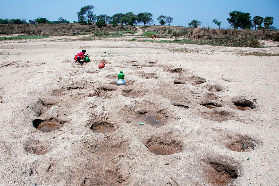 In most Purulia regions, women resort to digging small bore wells in dried-up ponds or natural reservoirs for drinking water. After allowing the water to settle, they strain the top layer before filling their buckets—a laborious process borne out of necessity amidst water scarcity. All images by Subrata Biswas