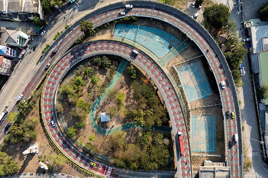 The Bangkok Metropolitan Authority operates around 40 parks, but intends to double that number by adding flora to small disused plots hemmed in by motorways or high-rise buildings. Image credit: Photography Manan VATSYAYANA / AFP