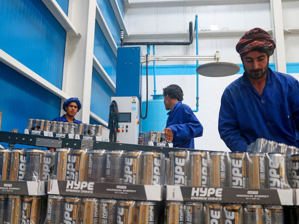 In this photo taken on August 12, 2024, Afghan workers process energy drinks at a factory in Herat. 
Image: Mohsen Karimi / AFP©