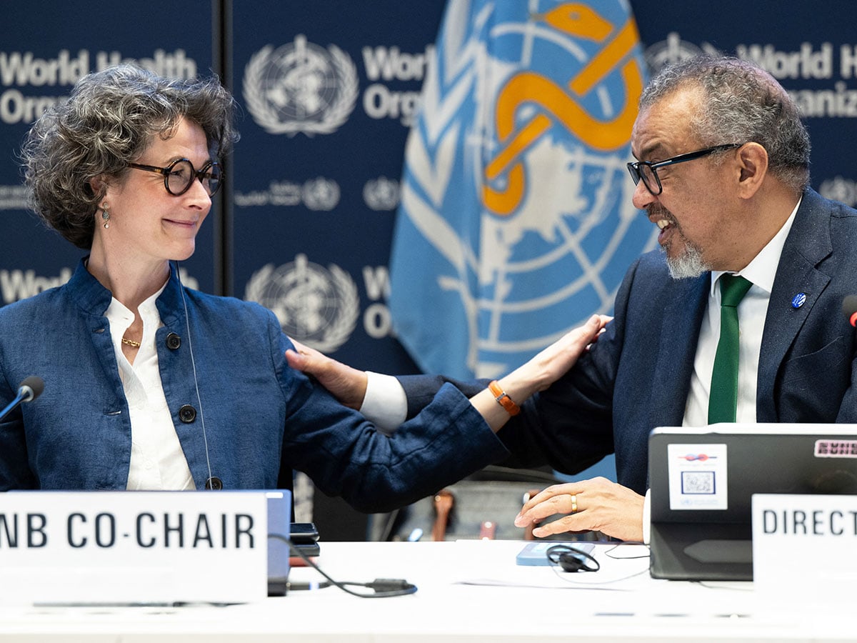 A handout photo shows Co-chair of the negotiations and French ambassador for Global Health Anne-Claire Amprou (left) and WHO Director-General Tedros Adhanom Ghebreyesus after a consensus on the Pandemic Agreement at the WHO headquarters  in Geneva on April 16, 2025.
Image: Christopher Black / WHO / AFP
