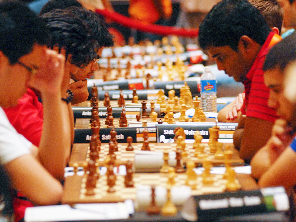 (File) Players take part in matches during the World Junior Chess Championship in Pune. 
Image: STRDEL / AFP