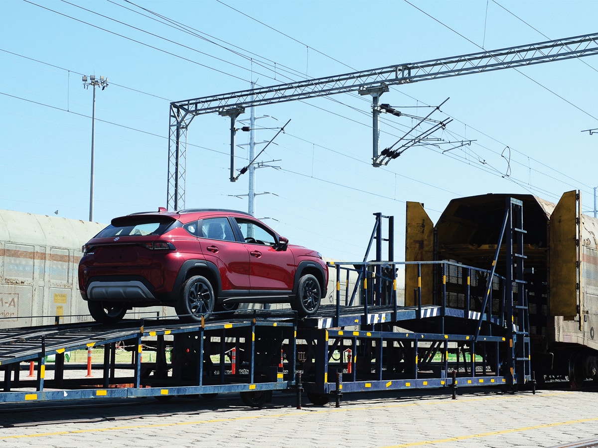 
A workers loads a Maruti Suzuki Fronx car model on a train at the Maruti Suzuki Hansalpur plant, some 80 km from Ahmedabad
Image: Sam Panthaky / AFP