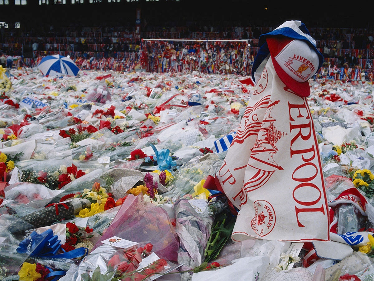 Floral tributes cover the pitch at Anfield, Liverpool, during a memorial ceremony held after the Hillsborough disaster, in which 96 Liverpool fans were killed in a crush at the Sheffield stadium, 22nd April 1989. Image: Georges De Keerle/Getty Images 