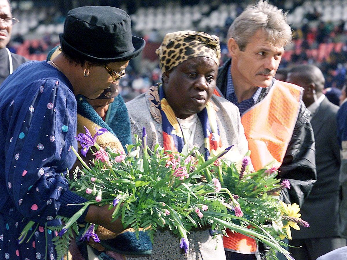 Grieving relatives are helped to lay a wreath for those who died at Johannesburg's Ellis Park soccer stadium April 15, 2001. 43 people were crushed to death during a match at the stadium on Wednesday in South Africa's worst sporting accident.
Image: JN/CRB/Reuters/Juda Ngwenya