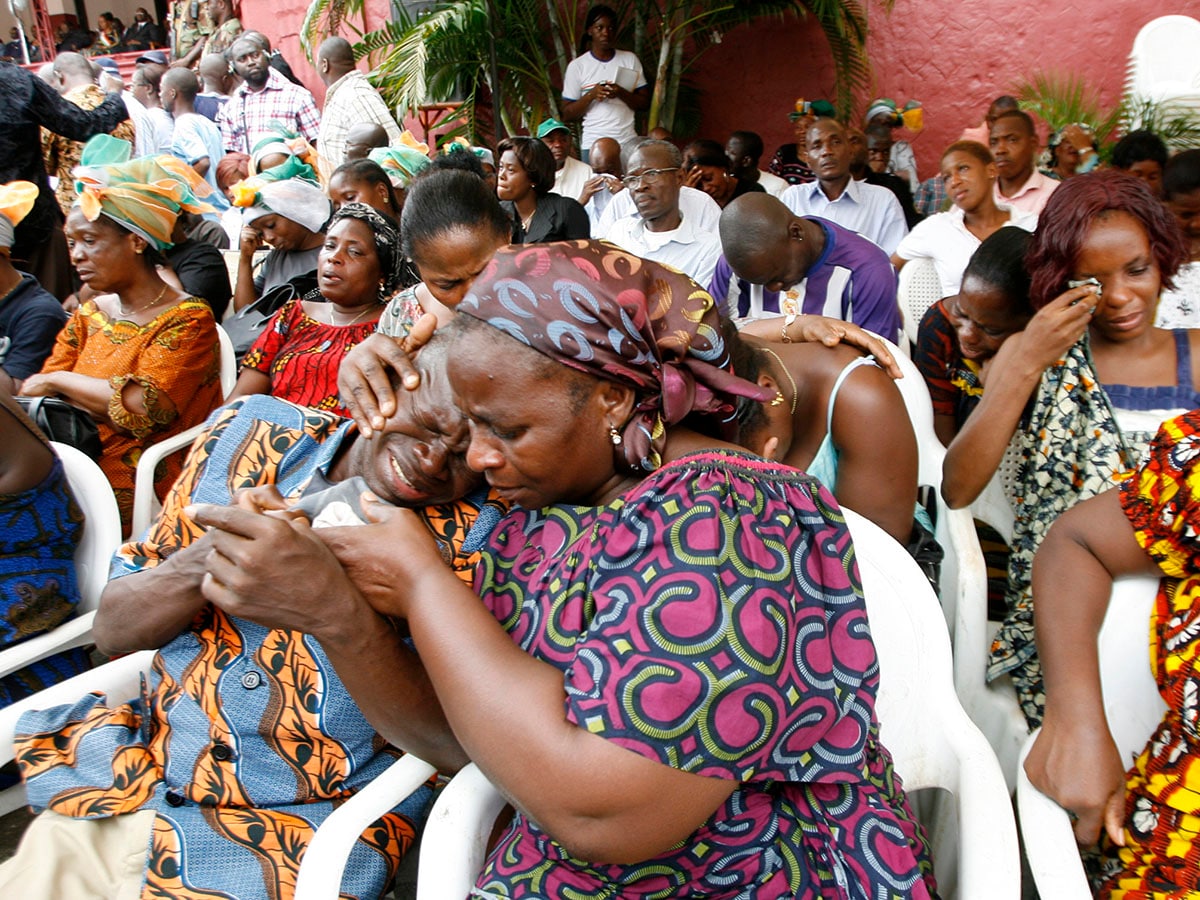 Friends and relatives of the victims of a stadium crush attend a memorial at Felix Houphouet Boigny stadium in Abidjan April 1, 2009. At least 19 people were killed in the crush during a World Cup qualifier between Ivory Coast and Malawi in Abidjan on March 29, 2009.  
Image: REUTERS/Luc Gnago   