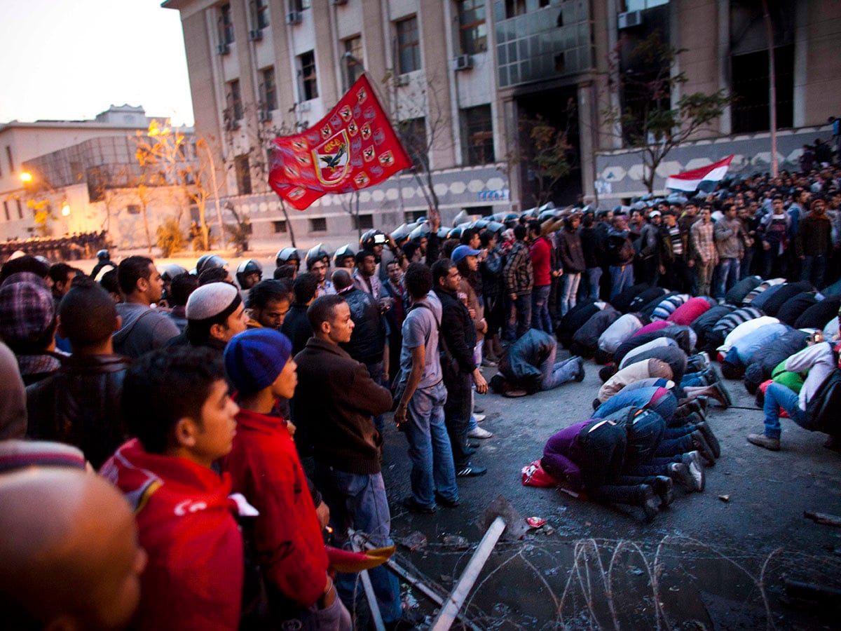 Protesters pray as they are blocked by police on their way to the interior ministry after a demonstration outside Cairo's Al Ahly football stadium on February 2, 2012 in Cairo, Egypt. The protest follows the deaths of 74 football fans who were killed in clashes between rival fans following the match between al-Masry and al-Alhy in Port Said, Egypt. Three days of mourning have been announced and marches are scheduled to protest at the lack of protection provided by police who were at the stadium when the violence occurred.  Image: Carsten Koall/Getty Images 