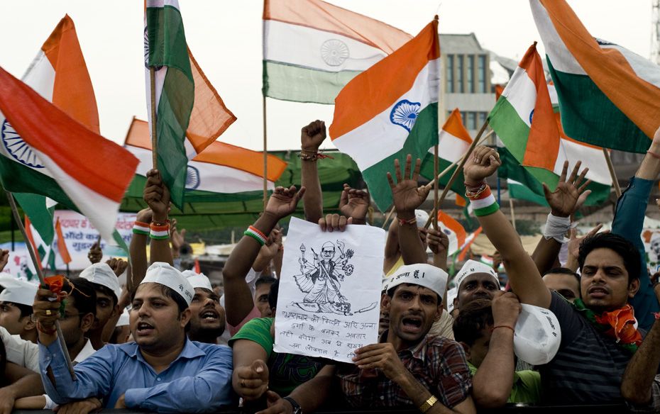 A supporter holds up a drawing depicting Anna as Goddess Durga                                      