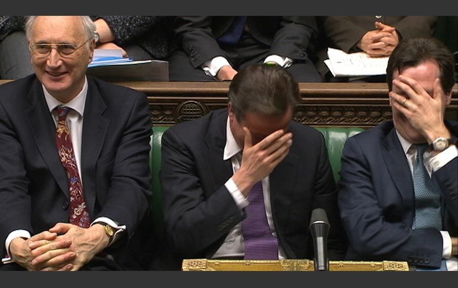 Britain's Prime Minister David Cameron (Centre) reacts during a parliamentary debate on last wee