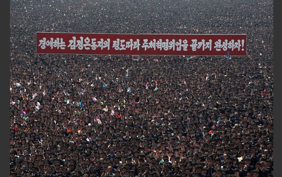 Follow The Leader Thousands of residents applaud at a square during the inauguration of a mosaic por