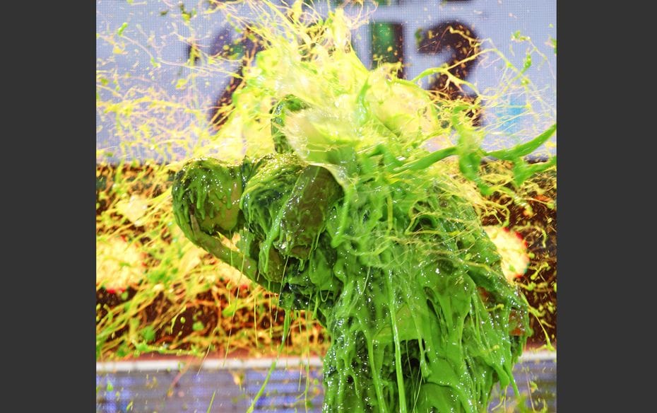 Slime Song Singer Justin Bieber (L) and host Will Smith are slimed on stage at Nickelodeon's 25t