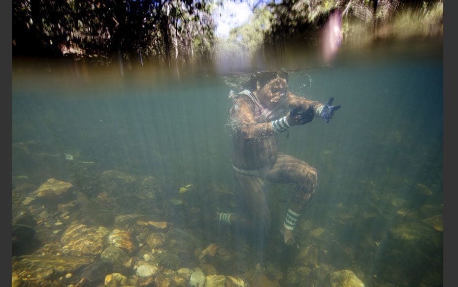 A Kayapo Indian takes a dip in the Sao Miguel River during the ‘Meeting of Traditional Culture