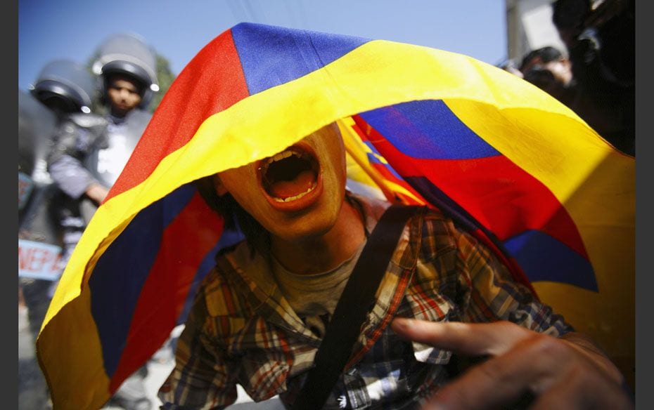 A Tibetan activist shouts slogans as he holds a Tibetan flag outside the United Nations Office in Ne