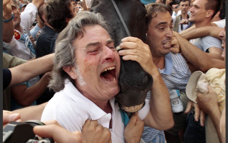 A supporter celebrates with the horse after jockey Luigi Bruschelli of the Onda (Wave) parish won th