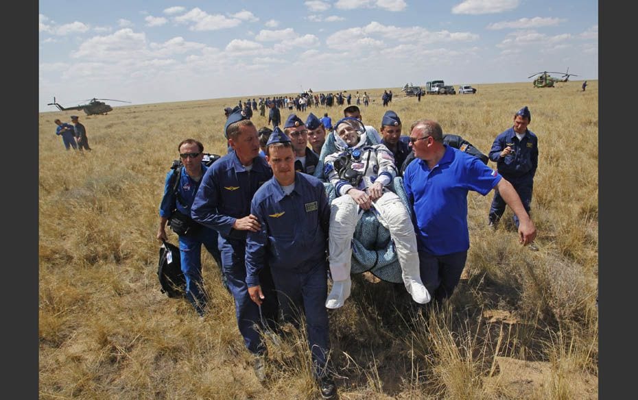 Support and medical personnel carry International Space Station (ISS) crew member Flight Engineer Do