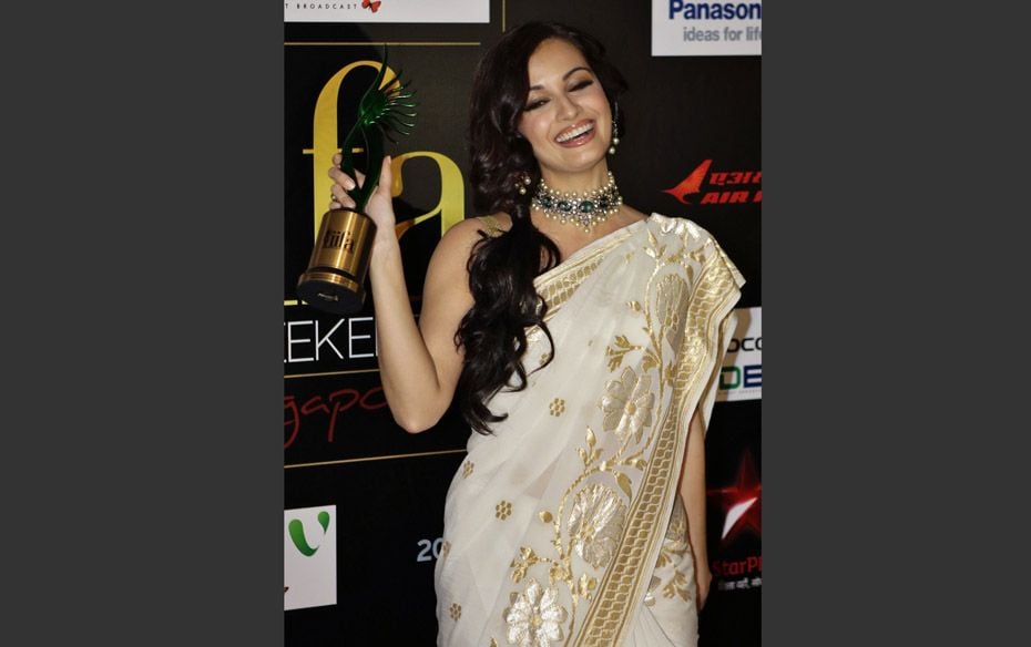 Bollywood actress Dia Mirza poses with the Green Award trophy backstage at the International Indian 