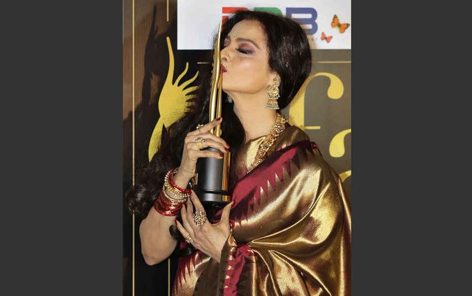 Bollywood actress Rekha kisses her Lifetime Achievement Award trophy,  backstage at the Internationa