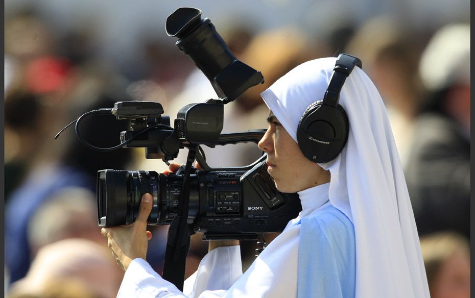 A nun films as Pope Benedict XVI leads his weekly audience in Saint Peter's Square at the Vatica