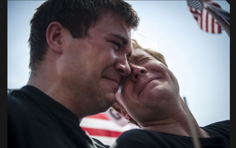 Michael Knaapen (L) and his husband John Becker, both of Wisconsin, react to the 5-4 ruling striking