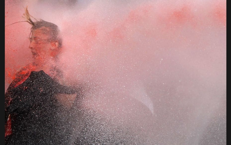 A woman is attacked by water cannon during protests in Kizilay square in central Ankara, Turkey. The