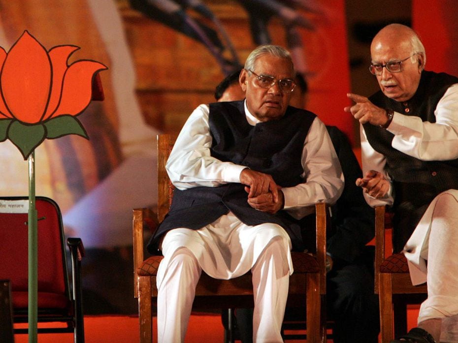 Atal Bihari Vajpayee and L.K. Advani next to the vacant seat of Pramod Mahajan during the BJP conven