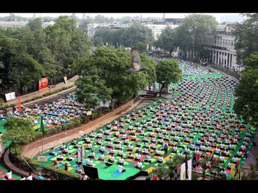 DELHI, INDIA - JUNE 21: Yoga practitioners gather at dawn in the inner circle of Connaught Place in 