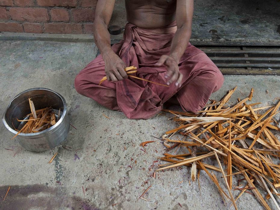 Red sandalwood, to be used as red dye, is broken into small pieces before being powdered            